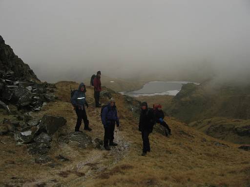 14_49-1.jpg - First club walk of the year - 7th January, and there is ice in patches. We climbed Easedale Gill from Grasmere to top out in the mist on High Raise. Climb OK, but lunch stop at the top was cold. Searching for Sergeant Man in the mist was also entertaining since there are many small summits to confuse. We have left the mist here and can see Easedale Tarn from Blea Rigg.